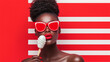 © Nokhoog - Woman with Red Sunglasses and Popsicle on Red and White Background
