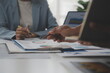 © Sutthicha - Close up of Business team analyzing income charts and graphs with modern laptop computer. Business analysis and strategy concept.