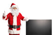 © Ljupco Smokovski - Santa claus with a tv screen gesturing thumbs up
