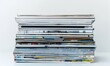 © Coosh448 - Stack of magazines on white background, 4K hyperrealistic photo