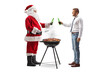 © Ljupco Smokovski - Santa claus toasting with beer with a younger man and making a bbq