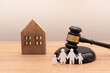 © Renata Hamuda - paper family cutout with gavel and wooden house model on wooden desk, Family law and heritage concept