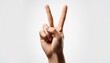 © intricateflow - A hand showing the finger gesture of a peace hand sign or a victory hand sign with a white background; the index finger and middle finger held up to show peace and victory; finger photography; white