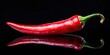 © methinee - Red hot chili pepper over black background