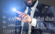 © Prostock-studio - Modern technology. Businessman choosing with finger analytic diagram with data on transparent screen