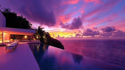 Wall Mural - a stunning sunset over the ocean with a serene pool in the foreground and a cozy restaurant on the o