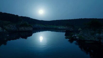Wall Mural - tranquil night with a full moon shining over a serene lake and lush forest, reflecting in the calm w