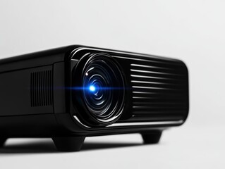 Black projector with blue light on a white isolated background.