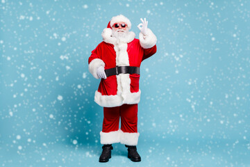 Poster - Full length body size view of his he nice content cool cheerful cheery fat bearded Santa wearing warm winter coat look outfit showing ok-sign isolated over blue turquoise pastel color background