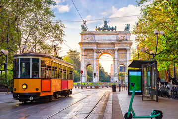 tram and scooters near arch