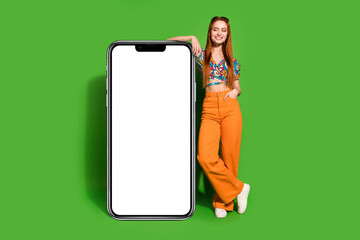 full size photo of pretty young woman look empty space large smart phone wear top isolated on bright