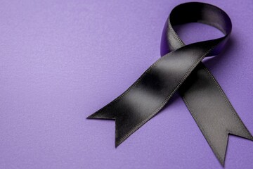 The purple ribbon on a pink background, a top view with space for text. International day against domestic violence.