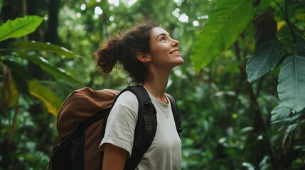 Poster - A young woman explores a lush green rainforest, admiring the towering trees and vibrant foliage during a sunny day