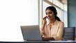 © l1gend - Happy Indian call center agent wearing headset talking to client working in customer support office. Professional contract service telemarketing operator using laptop having conversation. Candid shot