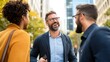 © LifeMedia - A diverse group of three people engage in cheerful conversation amidst an urban backdrop, exemplifying camaraderie and professional attire on the bustling street.