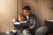© kieferpix - Father and son with book story, smile and bonding, education and learning in home. Reading, parent and child in bedroom for storytelling, happy and relax child care, growth and development