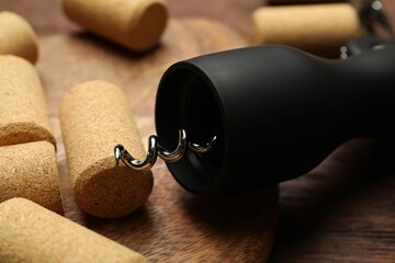 Poster - Wing corkscrew and corks on wooden table, closeup