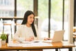 © Thitisak - business women sitting and working Documents in front of the computer