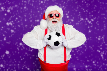 Sticker - Photo of grey haired santa father holding football ball spend newyear night watching champion league excited final game wear sun specs costume isolated purple background