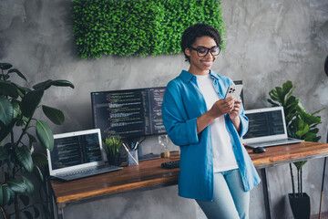 Photo of pretty young girl hold device coding wear blue shirt coworking programmer successful nice light office