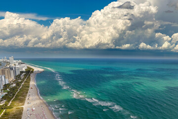 Wall Mural - Miami Beach city with high luxury hotels and condos and sandy beachfront. High angle view of tourist infrastructure in southern Florida, USA