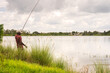© DEVIKA PRODUCTION - fisherman fishing in the river with a fishing rod