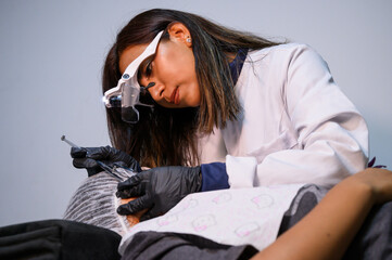 The professional cosmetologist with a patient in the office