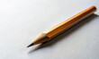 © Sunset - A simple wooden yellow pencil on a white table