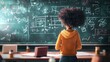 © Fana Art - A young woman with an afro stands in front of a blackboard covered in math equations. She is wearing a yellow hoodie and denim jeans.