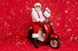 © deagreez - Portrait of his he nice bearded cheerful fat funky Santa hipster sitting on motor bike holding in hands big large gift congrats isolated on bright vivid shine vibrant red color background