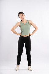 Wall Mural - Full body image of young Asian girl wearing sports outfit and posing on white background