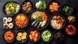 © milkyway - Assorted Korean Cuisine Dishes Served on Bowls and Plates Over Dark Background