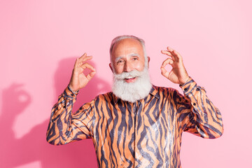 Photo of eccentric cheerful funny pensioner man wear stylish print clothes okey sign isolated on pink color background