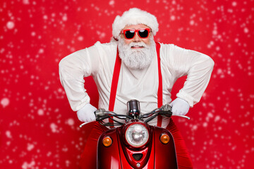 Wall Mural - Close-up portrait of his he nice attractive cool bearded cheerful brutal virile Santa riding bike delivering shopping orders isolated over bright vivid shine vibrant red color background