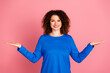 © deagreez - Young woman with curly hair in casual blue sweatshirt smiling against pink background for advertising and promotion