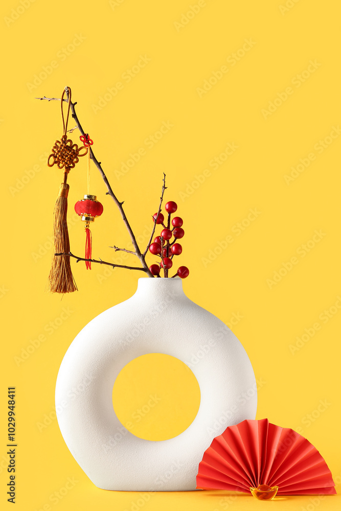 Vase with branch and oriental symbols on yellow background. New Year celebration