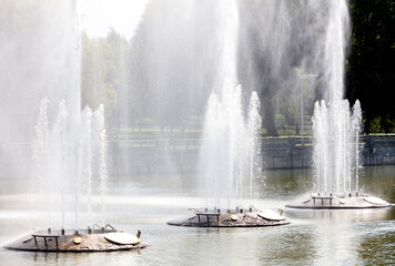 Three fountains are spraying water into the air