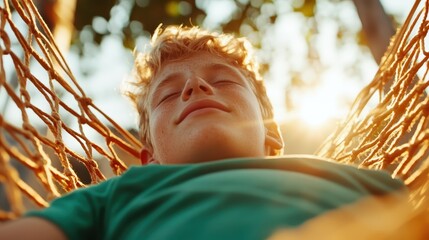 A young boy rests on a hammock with closed eyes, bathing in gentle sunlight amid a serene environment, enjoying the peaceful ambiance of a sunny day outdoors.