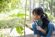 © K2L Family - A young girl is looking at a plant with a magnifying glass