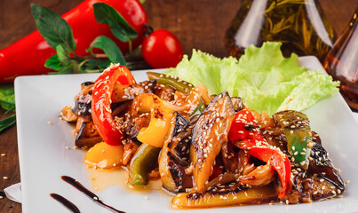 Delicious grilled vegetables with chicken and sesame seeds on white plate