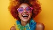 © Nataliia_Trushchenko - A person wearing a colorful clown wig and pink glasses, laughing heartily with their mouth open wide while standing against a yellow background. The individual is dressed in a green feather collar