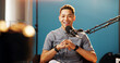 © Flashizzle/peopleimages.com - Live streaming, man and smile as radio presenter with microphone, talk show or entertainment. Male person, content creator and happy on podcast host in studio for recording audio or social media
