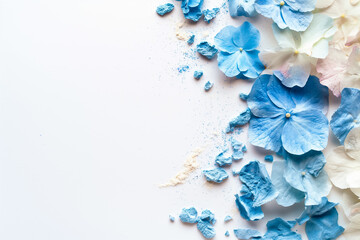 Wall Mural - Soft hues of blue and white hydrangea petals are elegantly scattered across a clean, white backdrop, creating a serene and artistic display of nature beauty