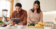 © WesLens/peopleimages.com - House, cooking and couple with tablet, nutrition and bonding together with ingredients. Apartment, man or woman in kitchen, hobby or technology with internet, online reading or website for recipe