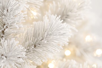 Wall Mural - white artificial pine branches with warm glowing lights on a bright white background.