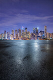 Asphalt road square and modern city buildings scenery at night. car background.