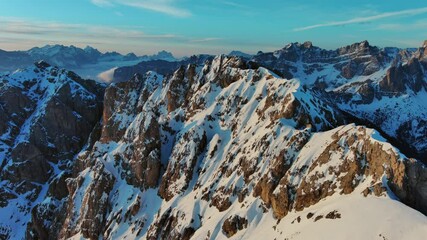 Wall Mural - aerial view of amazing rocky mountains in snow at sunrise, dolomites, italy, 4k