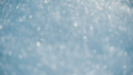 Beautiful crystal white background. White snowflakes in a defocused form. White snow.