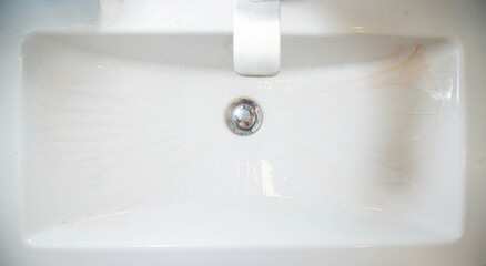 Limescale deposits on the bathroom sink. Cleaning and washing bathroom fixtures. Cleaning services, copy space for text