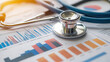© Suphawan - A stethoscope placed on top of financial documents and graphs, representing the intersection of healthcare and business strategy.